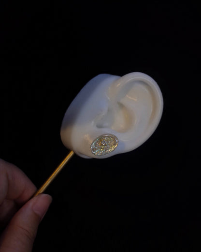 White seashell piercing